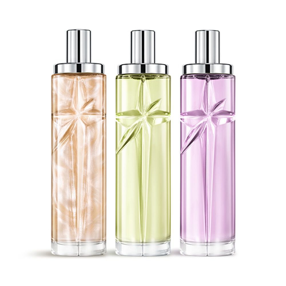Starlicious the yummy swirl paquet superpose avec Pineapple Musk, Pistachio Praline et Berry Licorice, des bouteilles en verre avec une etoile filante sculptee, dont les facettes brillaient sous un lisse-bouchon argente.