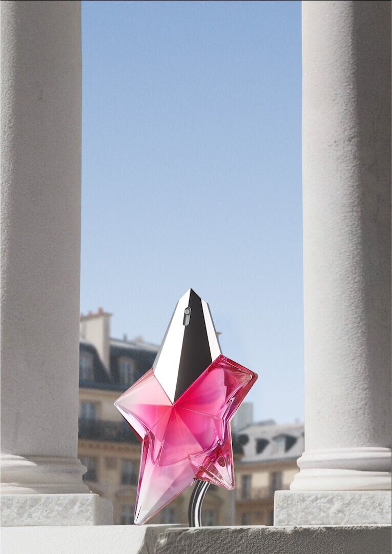 Mugler Mother's Day 2026 campaign banner featuring the iconic Angel Nova Eau de Parfum perfume bottle in a celestial floral and Parisian landscape, celebrating extraordinary mothers.