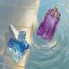un flacon de parfum en forme d'etoile bleu et un autre violet poses dans un fond piscine