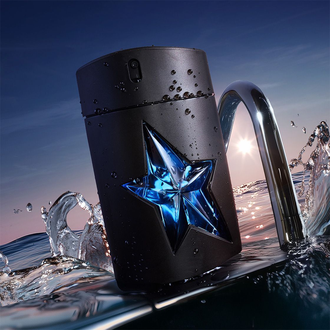 flacon noir eau de parfum mugler posé sur l'eau